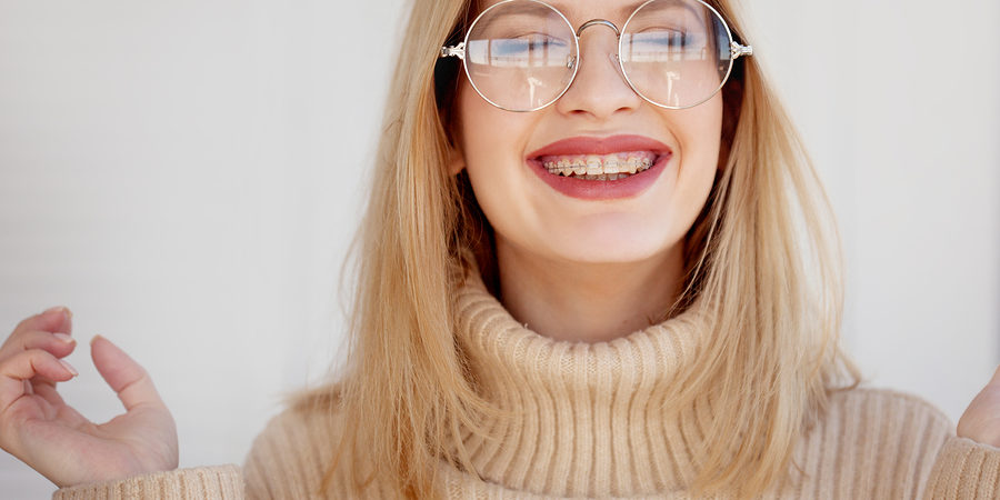 Stylish And Beautiful Young Blonde With Glasses And Beige Oversi