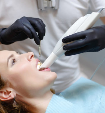 The dentist scans the patients teeth with a 3d scanner