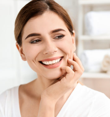 Young woman with beautiful smile indoors. Teeth whitening